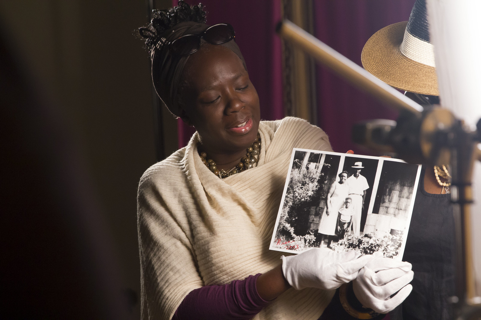 A woman holding an archival family photograph