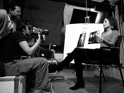 Thomas Allen Harris and his crew filming a woman holding archival photographs