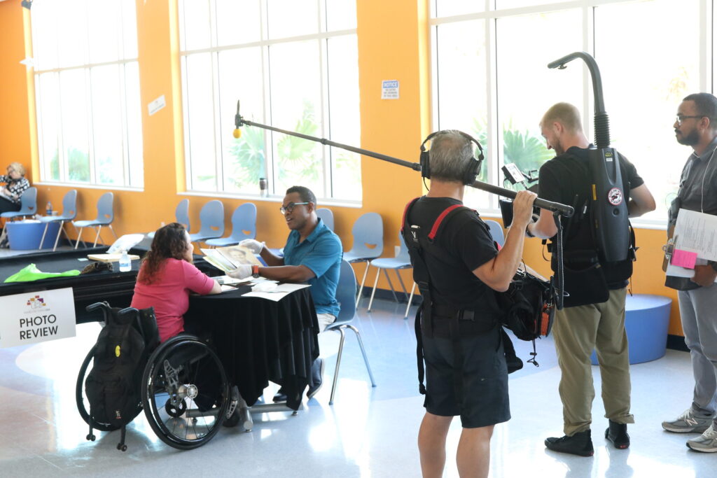 A Family Pictures camera crew filming an interview with a women discussing her family photographs