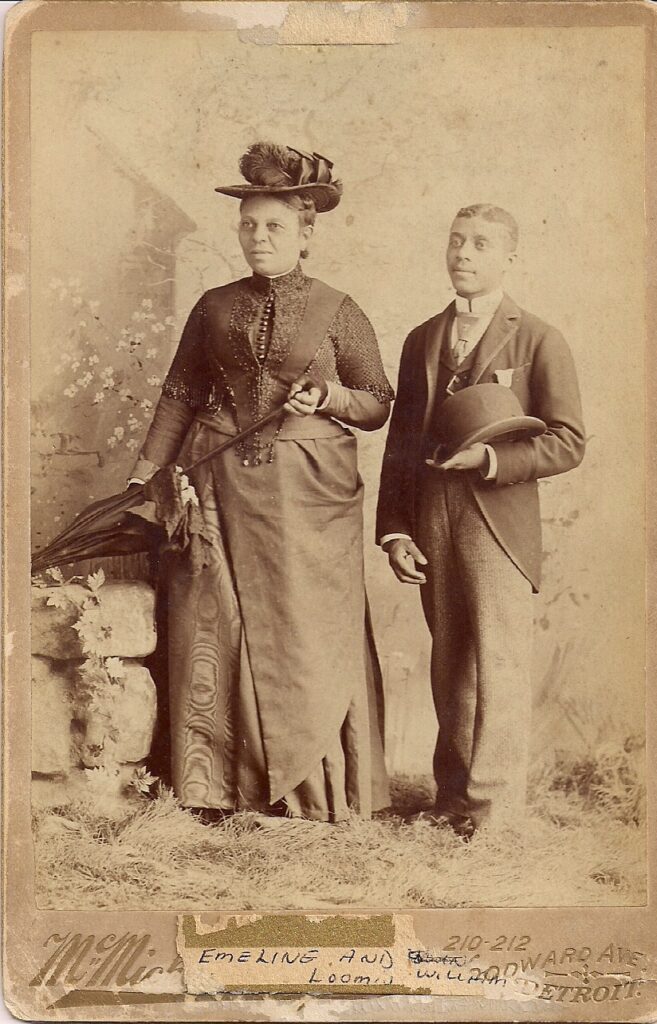 An archival black and white photograph of a man and woman, captioned "Emeline and William Loomis"